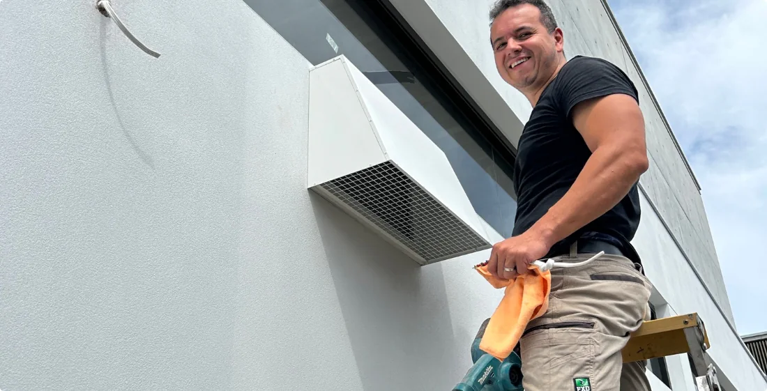 An electrician from Sydney Rangehoods installing a rangehood